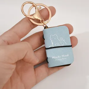 Mini PU leather notebook keychain, cute cat design backpack charm, 4cm portable pendant key ring.