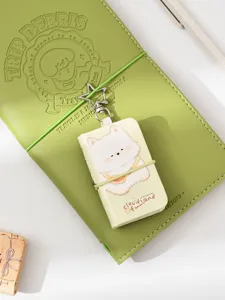 Green leather traveler notebook with cute puppy keychain mini booklet, portable aesthetic journal diary.