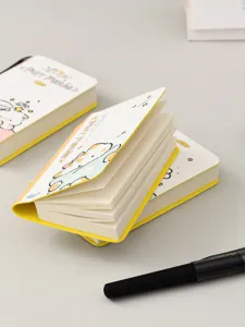 Macro detail of cute Purr Mates mini pocket notebooks with yellow covers and white pages