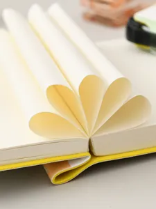 Detailed close-up of a mini portable notebook with pages folded in a creative fan shape.