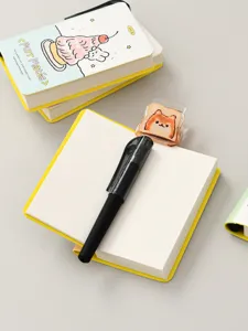 Detail of mini portable notebook showing pen holder slot and black pen