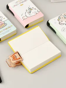 Detailed view of an open mini pocket notebook with a cute cat toast acrylic clip