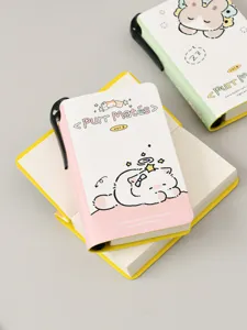 Detailed view of cute mini pocket notebook featuring a pen holder and cat illustration