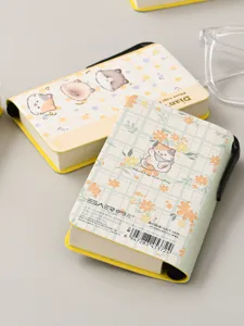 Close-up detail showing the cute cat illustration pocket notebook with plaid design.