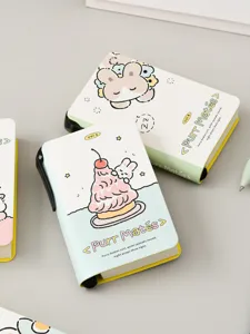 Close-up of cute Purr Mates mini notebook featuring a convenient side pen slot