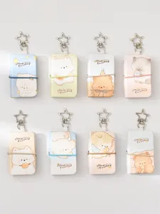 Mini cute cartoon notebook keychain detail showcase with colorful animal cover and star pendant.