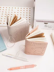 Detailed view of portable leather travel notebooks with cute embossed cat and dog characters.