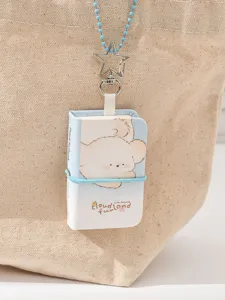 Mini notebook keychain pendant close-up, cute puppy illustration, detailed backpack charm.