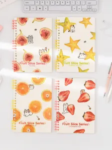 Detailed close-up of cute fruit slice design loose-leaf notebooks with lovely cats on desk.
