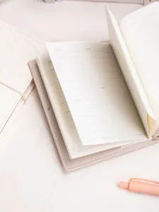 Close-up detail of the inner pages of a leather daily planner journal with to-do list layout