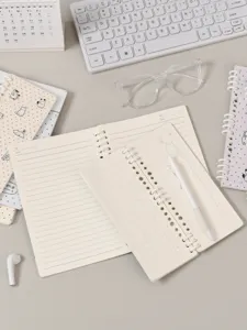 A5 ringband notebook met gesegmenteerde spiraal, gelinieerde pagina's en schattige cartoonomslag.