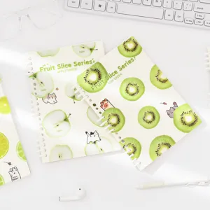A5 spiral notebook with green fruit slice and cute cat illustrations, fresh student stationery.