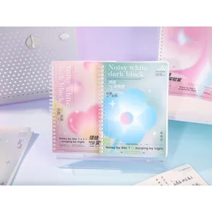 Close-up detail of soft spiral notebook with artistic heart and flower gradient cover