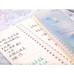 Close-up of soft spiral bound notebook with horizontal lines and artistic cover design