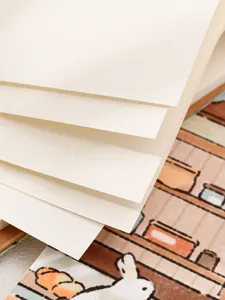 Close-up of blank ivory paper pages in an A4 student sketchbook with soft texture