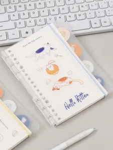 Close-up detail of the 6-ring loose leaf notebook featuring cute cat cover illustrations.
