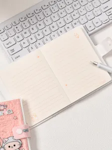 Detail showing inner pages and soft plush cover of the cute cat themed notebook.