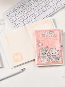 Detailed view of a pink plush cat-themed notebook with cute cartoon characters on cover
