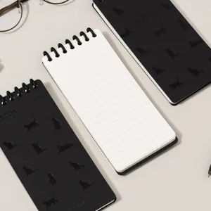 Portable pocket spiral notebook with lined pages, minimalist black and white cover design.