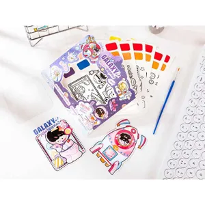 Close-up of DIY watercolor coloring book set with cute space astronaut illustrations and brush.