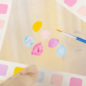 Children watercolor painting tool detail view, clear palette, paintbrush and colorful swatches.