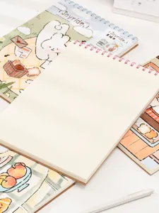 Close-up of a top-spiral sketchbook with blank pages and cute rabbit cover design