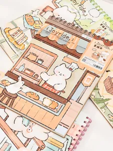 Close-up of A4 spiral-bound sketchbook with cute cartoon bakery illustration