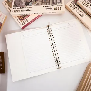 Detailed view of the B5 loose-leaf lined notebook with refillable paper and metal binder rings.