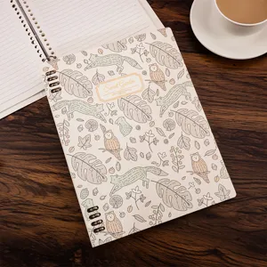 Detailed view of B5 loose-leaf lined notebook featuring forest animal cover pattern and spiral binding.