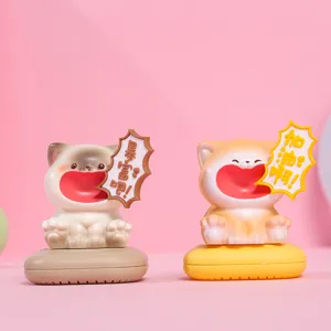 Close-up of two creative screaming cat figurines with motivational speech bubbles.