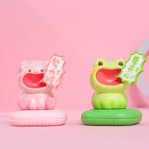 Detail of cute screaming pig and frog resin figurines with fragrance box bases.