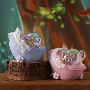 Close-up of creative iridescent polar bear resin ornaments in purple and pink cradles.