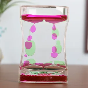 Close-up of a decorative double color liquid motion timer with pink and green drops