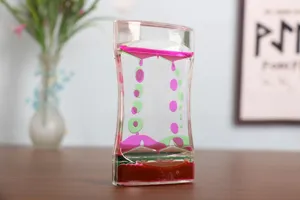 Side view of a creative liquid bubbler timer showing pink and green oil droplets