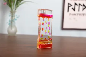 Close-up of liquid motion bubbler with pink and yellow oil droplets for relaxation