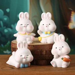 Macro view of four cute cartoon rabbit figurines used as creative desktop phone stands
