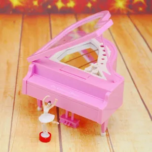 Detailed close-up of a pink grand piano music box featuring a rotating ballerina figurine