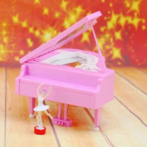 Detail showing a pink piano-shaped music box with a spinning ballerina girl figurine.