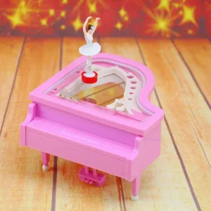 Macro detail of a creative pink piano music box featuring a rotating ballerina figurine