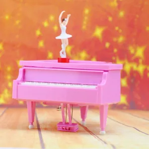 Detailed side view of a pink piano-shaped music box featuring a rotating ballerina doll.