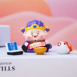 Close-up of cute Caishen figurine with office-themed accessories for desk decor