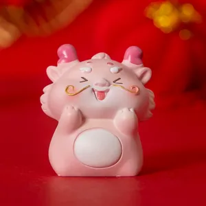 Detailed view of cute pink dragon mascot figurine on a festive red background ornament