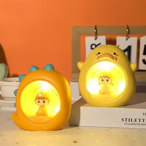 Ein Paar süße gelbe Enten- und Dinosaurier-Nachtlichter für Schlafzimmer-Ambiente