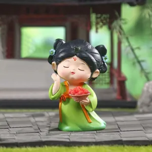 Close-up of a cute Tang Dynasty style girl resin figurine holding a fruit basket