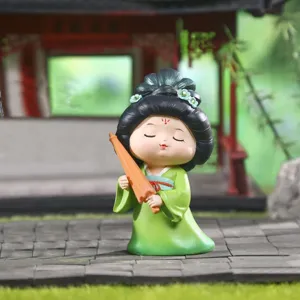 Cute Tang Dynasty style girl resin figurine in green hanfu holding an orange umbrella