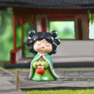 Close-up of Tang Dynasty style girl resin figurine in a traditional garden setting.