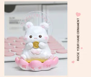Close-up of a cute faceted hamster figurine on a pink lotus base for desk decor