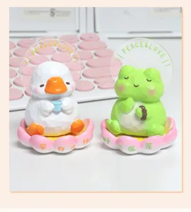 Cute meditating duck and frog resin figurines sitting on pink lotus bases for desk decor