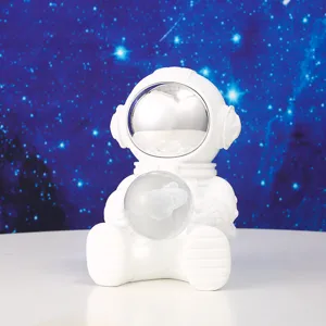 Close-up view of a cute white astronaut figurine holding a crystal ball night light