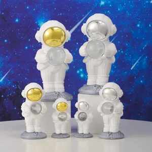 A group of six creative white astronaut night lights with gold and silver visors